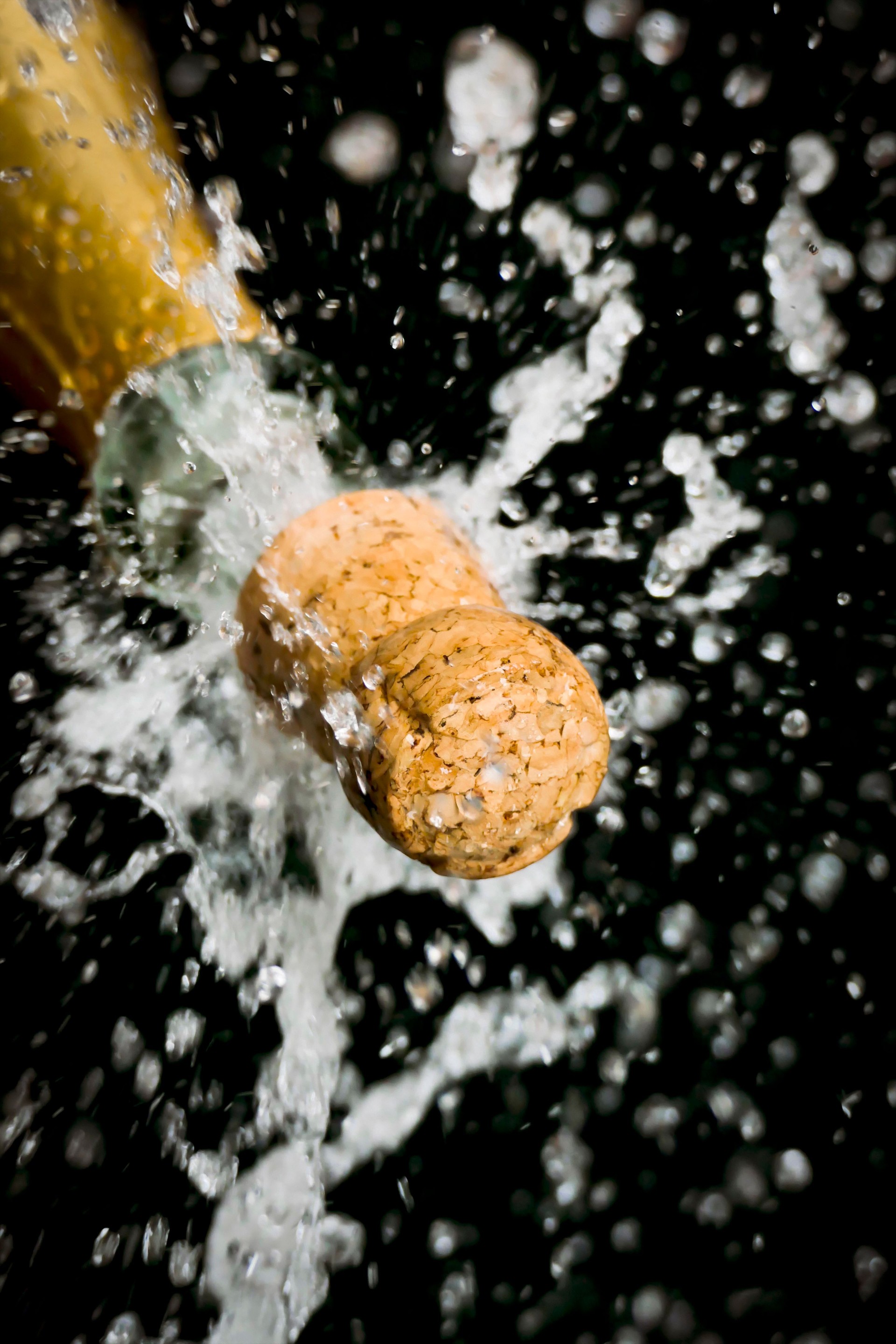 a champagne cork is popping out